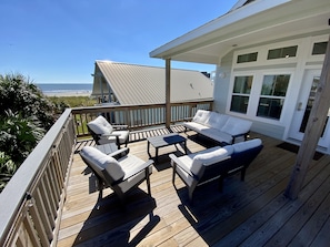 Comfortable outdoor seating for coastal enjoyment on the expansive back deck!