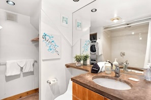 The full bathroom has a washer and dryer, tub and shower combo and the closet for the condo.