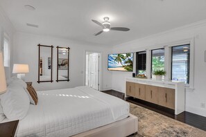 The primary bedroom offers direct access to the heated pool.