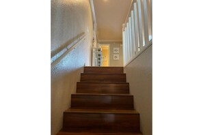 Head up the first flight of stairs to the main level of the home.