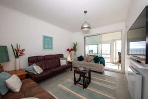 Get comfortable in the living room as you settle in for a movie night on the large wall mounted TV