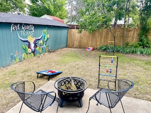 Fenced in backyard w lawn games, firewood(guest must provide) & art mural