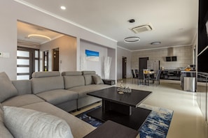 A classy living room with a large and comfy sofa.