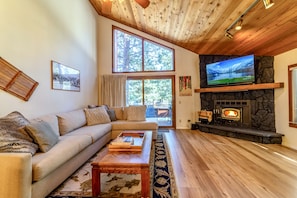 Living room has comfortable pull-out sleeper sofa, large flatscreen TV and wood burning fireplace.