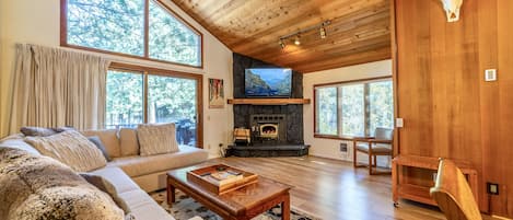 Gorgeous living room with vaulted ceilings and new luxury vinyl flooring throughout.