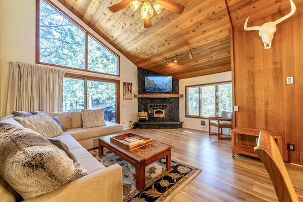 Gorgeous living room with vaulted ceilings and new luxury vinyl flooring throughout.