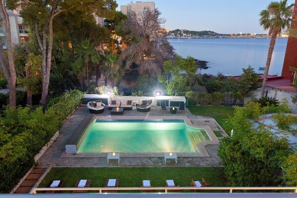 Exterior view from the beach house over the garden with sea views 