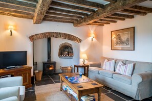 Ground floor: Sitting room with wood burning stove and slate floor