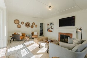 Sunken living room with fireplace and tv