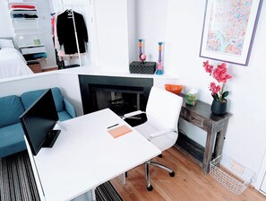 Desk with office chair, 2nd screen, cords, WiFi, and office supplies.