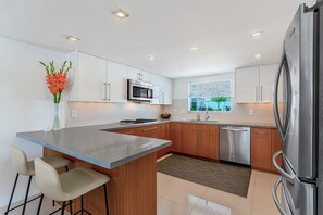 Fully stocked kitchen with breakfast bar seating