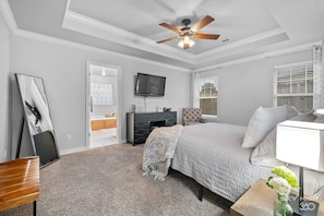 Primary/Master bedroom with king bed, bench for suitcases, lounge chair etc.