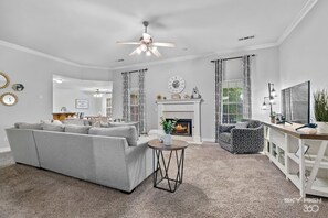 Living room with sectional, swivel chair and gas fireplace!