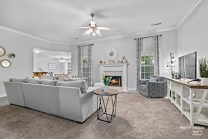 Living room with sectional, swivel chair and gas fireplace!