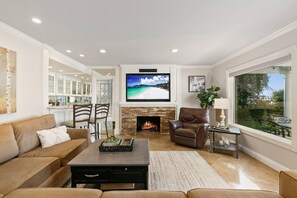 Family room with fireplace, comfortable seating and smart TV