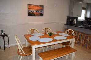 Dining area with seating for 6 at the table and 5 at the bar.