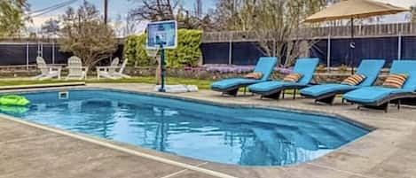 The outdoor oasis has a heated pool, fire pit, yard games and plenty of seating!