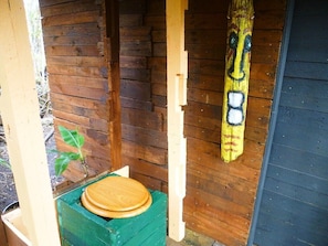 Indoor/outdoor composting toilet with tiki mask