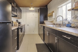 Full kitchen with stove, oven, refrigerator, and coffee maker