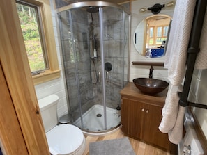 Bathroom with shower and copper sink.