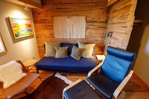 TV Room: Sleeper sofa (single), original scantling wood walls, & river views.