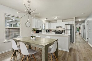 Cook, gather, and connect in the heart of Oak Grove Bungalow—this bright kitchen and dining space features stainless appliances, seating for six, and modern charm.