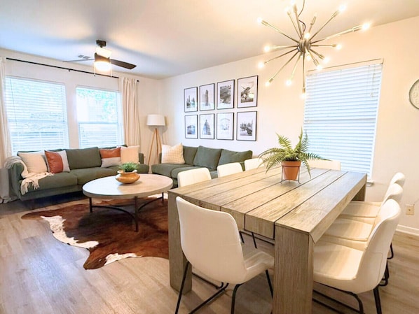 Perfect for group getaways! The bright living and dining area at Oak Grove Bungalow offers space to relax, dine, or play games with seating for everyone.