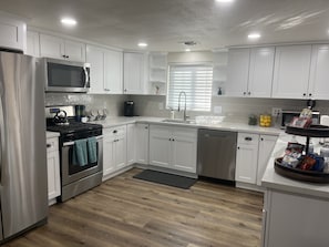 Newly Remodeled Kitchen with Calcutta Quartz Countertops