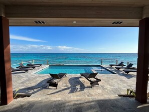 Morning view over pool, large pool patio and hot tub over the cerulean seas