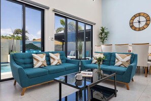 Step into comfort! This stylish living room, with its modern furnishings, is ready for your next escape.