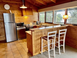 Well equipped kitchen with great views - new stove, fridge and dishwasher. 