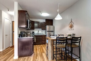 Rustic wood dining table in a cozy kitchen setting.