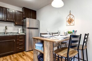 Rustic wood dining table in a cozy kitchen setting.