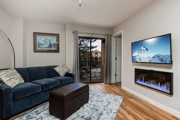 Living Room with Fireplace and Large TV plus Patio Access