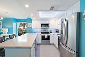 Updated beautiful kitchen with quartz countertops and stainless steel appliances