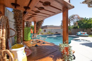 Delightful outdoor space  -  great pool, spa, grass covered yard, & custom bar!