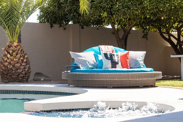 Lounge in the comfortable daybed and pick fresh lemons oranges from the trees.
