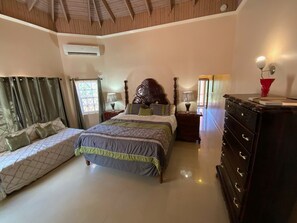 Bedroom 1 (primary), with en suite bathroom. King bed plus twin bed.