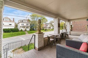 Your front porch includes outdoor seating, dining tables, couches and guard lions.