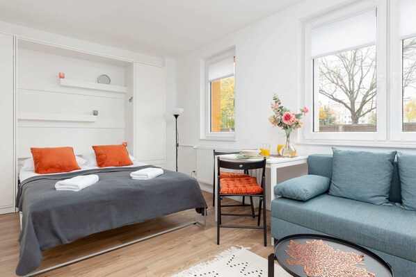 Studio with a double sofa bed, double bed and dining area.