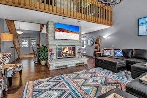 Family room with large screen TV, gas fireplace and radiant floor heat