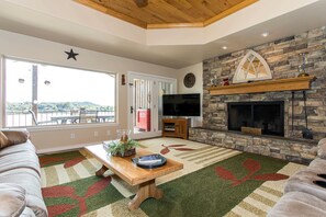 Living room with cable TV, fireplace, and comfortable seating