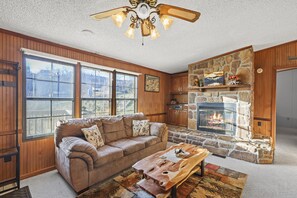 Experience the rustic embrace of our living room – where every detail tells a story of comfort, from the wooden beams to the crackling fireplace. 🏡