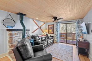 Cozy Corner: Embrace the warmth of home with a plush sofa, chic coffee table, a comforting gas stove, and a Smart TV – your perfect setup for movie nights. Step outside to the deck for a breath of fresh air. ️