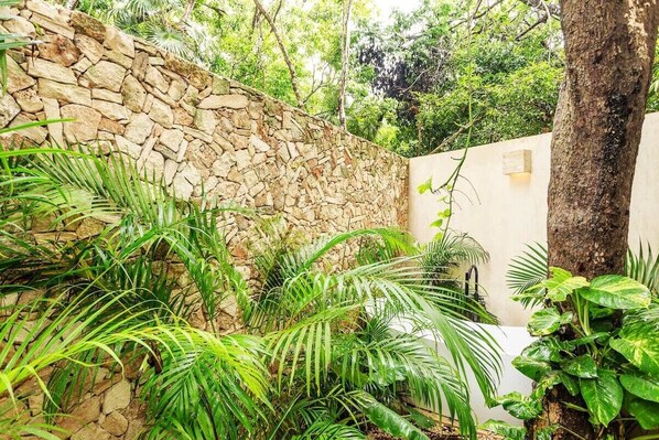 The ground-level, garden patio has a hidden bathtub!