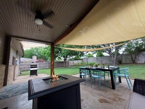 Backyard for your BBQ dinner or party with grill and dining set