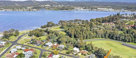 House backs onto a tidal creek with playing field beyond.