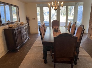 Home's dining room that comfortably seats 8.
(View of the patio and backyard.)