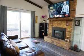 A new 65 inches smart TV with Netflix and a cozy fireplace.