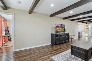 Living room toward master bedroom #1 w ensuite (left door) and kitchen (right). 